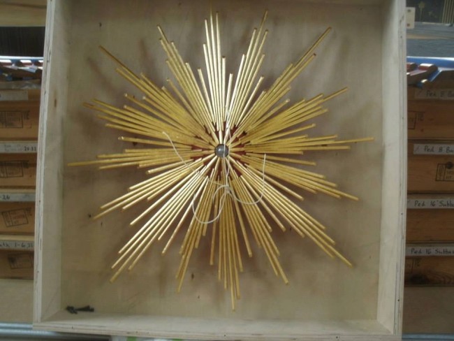 The zimbelstern star, which is about 18" in diameter and gilded, traveled in its own custom-made box. The string is to assist with handling. — at Merton College, University Of Oxford.